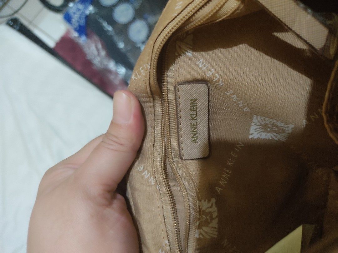 Anne Klein Embossed Logo Crossbody Bag (Category: Cross-body Bags) located in Cavite. Submitted by perfectfinds (Listing ID 1412113526, Image 3). Description: - Anne Klein crossbody bag - Neutral beige color - Embossed logo design - Top handle and chain swag - Main compartment with multiple pockets - Detachable strap for versatile carrying Bought for my self for approximately 2,500. never used it. .