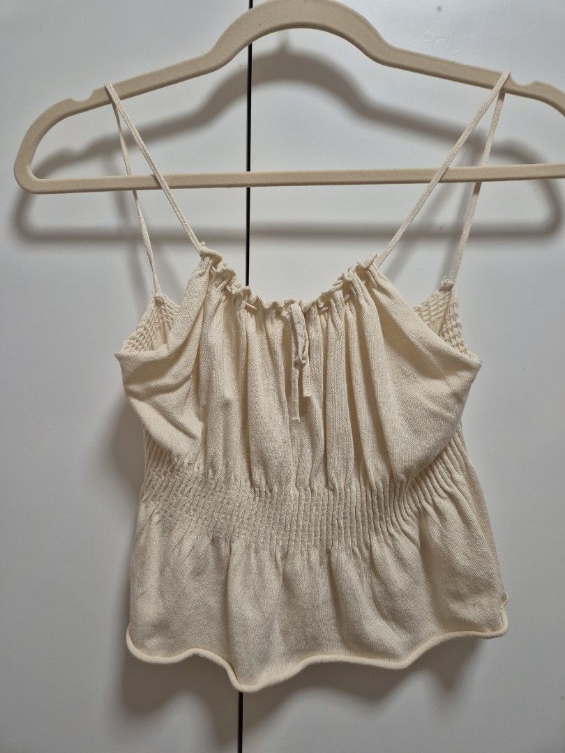 Cream-colored sleeveless Cami Top (Category: Sleeveless) located in Antipolo. Submitted by declutteringkingking (Listing ID 1412014522, Image 1). Description: - Cream-colored cami top - Spaghetti straps - Ruched bodice - Ruffled hem - Gathered bust detail - Soft, lightweight fabric - Versatile for different occasions. perfect for PH weather.