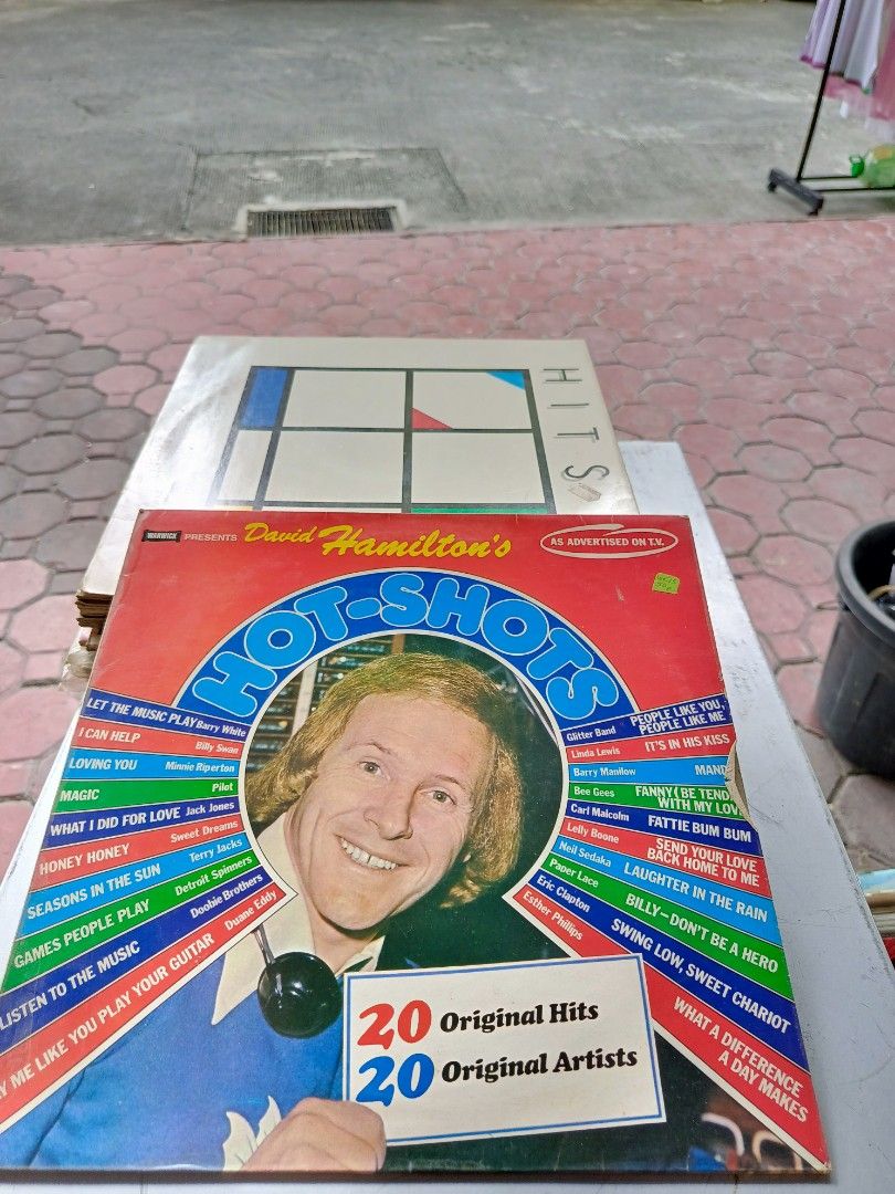 David Hamilton's Hot-Shots Vinyl Record (Category: Vinyls) located in Paranaque City. Submitted by kikosgarage (Listing ID 1412064711, Image 1). Description: Vinyl record features David Hamilton's Hot-Shots with 20 original hits from 20 original artists. The album includes songs like "Let the Music Play", "I Can Help", "Loving You", "What I Did for Love", "Honey Honey", "Seasons in the Sun", "Games People Play", and more. A great addition to any 