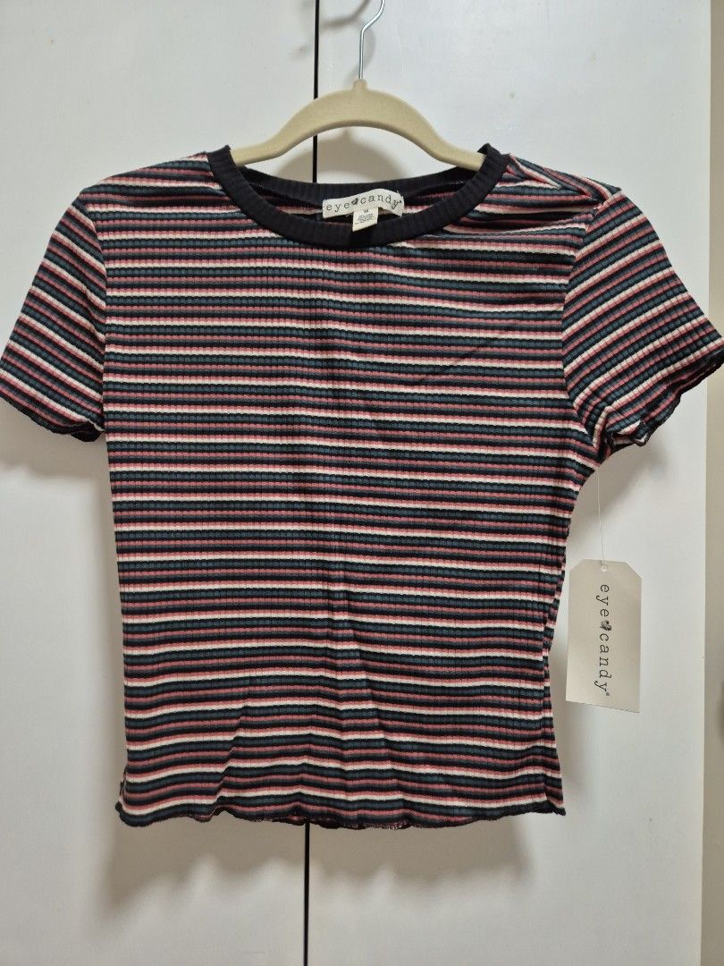 Eyecandy Striped Ribbed Top (Category: Sleeveless) located in Antipolo. Submitted by declutteringkingking (Listing ID 1412029817, Image 1). Description: - Striped pattern - Ribbed texture - Round neckline with black trim - Short sleeves - Wavy hemline - Casual style - Suitable for everyday wear.
