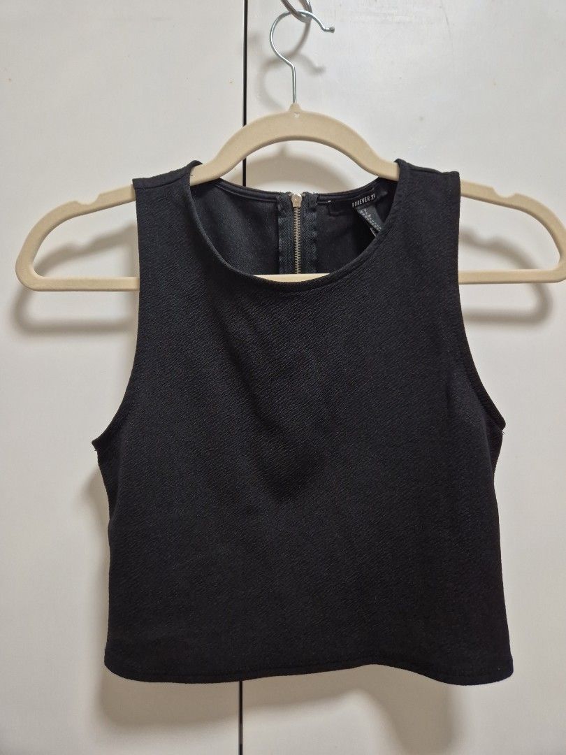 Forever 21 Black Sleeveless Crop Top (Category: Sleeveless) located in Antipolo. Submitted by declutteringkingking (Listing ID 1412015298, Image 1). Description: - Forever 21 sleeveless top - Black color - Zipper closure at the back - Textured fabric - Can be dressed up or down - Great for layering.