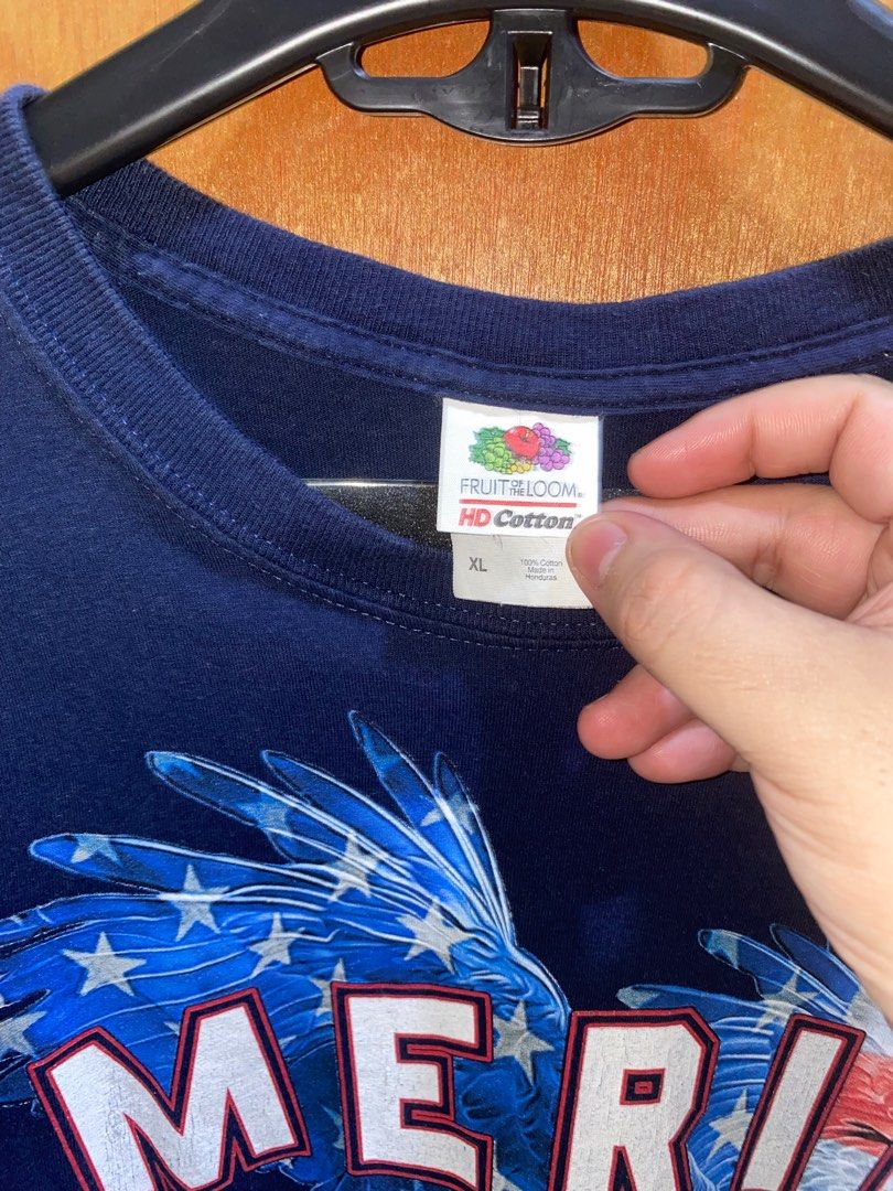 FOTL America Graphic Tee (Category: Tshirts & Polo Shirts ) located in Pasig City. Submitted by dzeims (Listing ID 1412090629, Image 3). Description: - Navy blue Fruit of the Loom t-shirt - Excellent Condition - Color rate: 9/10 - Size: XL on tag - Dimes: W23 x L28 - Design: American eagle graphic with "America" and American flag - Issue: Crack Prints 🏷️ 200 + Sf 📍Pasig City .