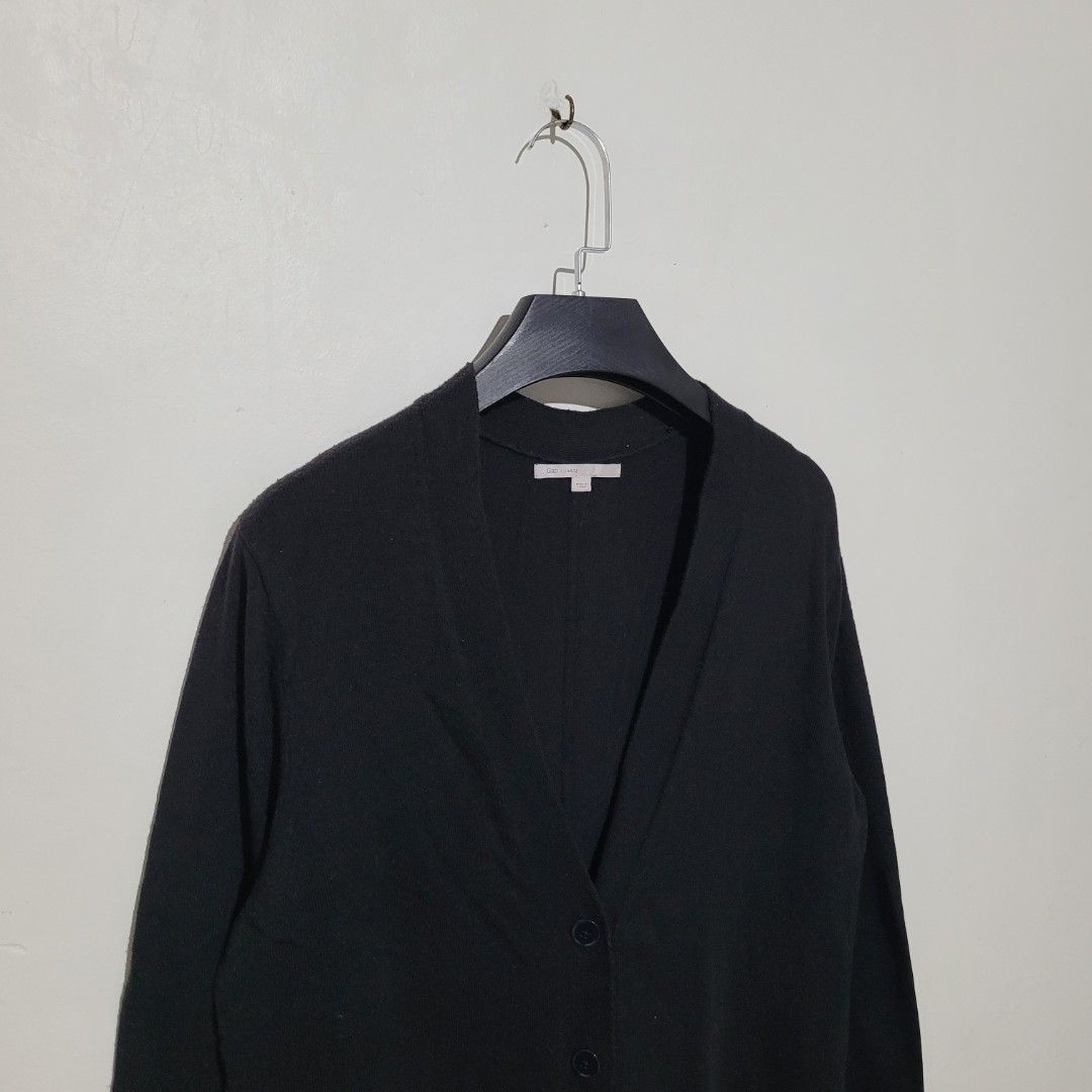 Gap Black Cardigan (Category: Coats, Jackets and Outerwear) located in Quezon City. Submitted by eivan____orong (Listing ID 1411986219, Image 2). Description: Medium to Large fittings 📐 28L x 19-20w Good Condition 1 missing button - Gap black cardigan - V-neck - Button closure - Made in Japan - Material: 55% nylon, 30% wool, 15% acrylic - Minor hole on sleeve.