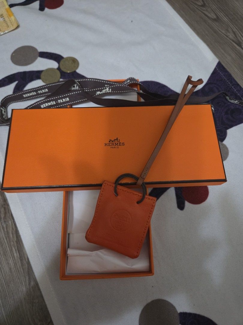 Authentic Hermes Sac Orange Leather Bag Charm (Category: Luxury Bags & Wallets) located in Manila. Submitted by sterling_grace (Listing ID 1412024944, Image 1). Description: - Authentic Hermes key holder - Orange leather - Includes original box and ribbon - Features Hermes logo tag and leather strap - Securely holds keys - Stylish and functional accessory.