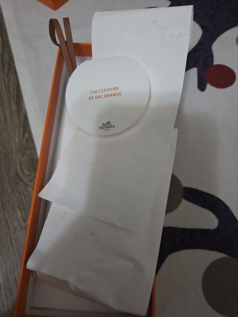Authentic Hermes Sac Orange Leather Bag Charm (Category: Luxury Bags & Wallets) located in Manila. Submitted by sterling_grace (Listing ID 1412024944, Image 3). Description: - Authentic Hermes key holder - Orange leather - Includes original box and ribbon - Features Hermes logo tag and leather strap - Securely holds keys - Stylish and functional accessory.