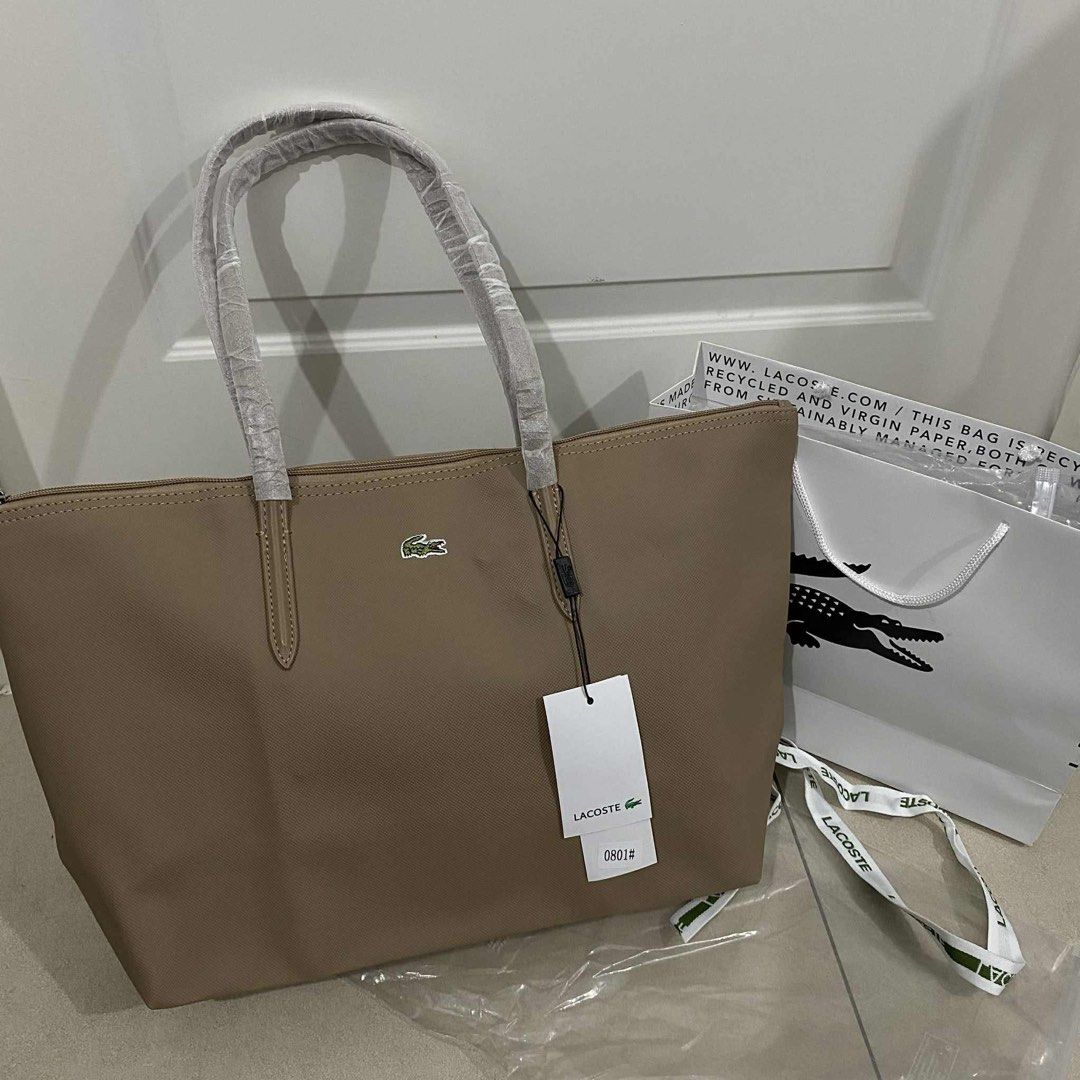 Lacoste Tote Bag - PM to ORDER (Category: Tote Bags) located in Quezon City. Submitted by declutter_summer (Listing ID 1412112189, Image 1). Description: • Brand new - Vietnam Made • With ziplock, tags, and ribbon • Available Colors: Light Blue, Khaki, Navy, Black, Fuschia Pink, Lavender, Maroon, Gray, Light Pink, etc. • Send us a DM to order.