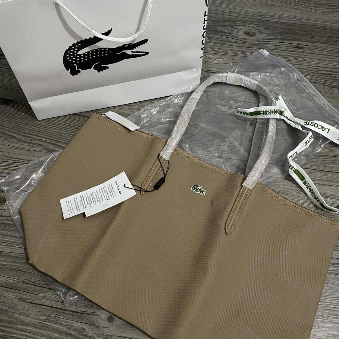 Lacoste Tote Bag - PM to ORDER (Category: Tote Bags) located in Quezon City. Submitted by declutter_summer (Listing ID 1412112189, Image 3). Description: • Brand new - Vietnam Made • With ziplock, tags, and ribbon • Available Colors: Light Blue, Khaki, Navy, Black, Fuschia Pink, Lavender, Maroon, Gray, Light Pink, etc. • Send us a DM to order.