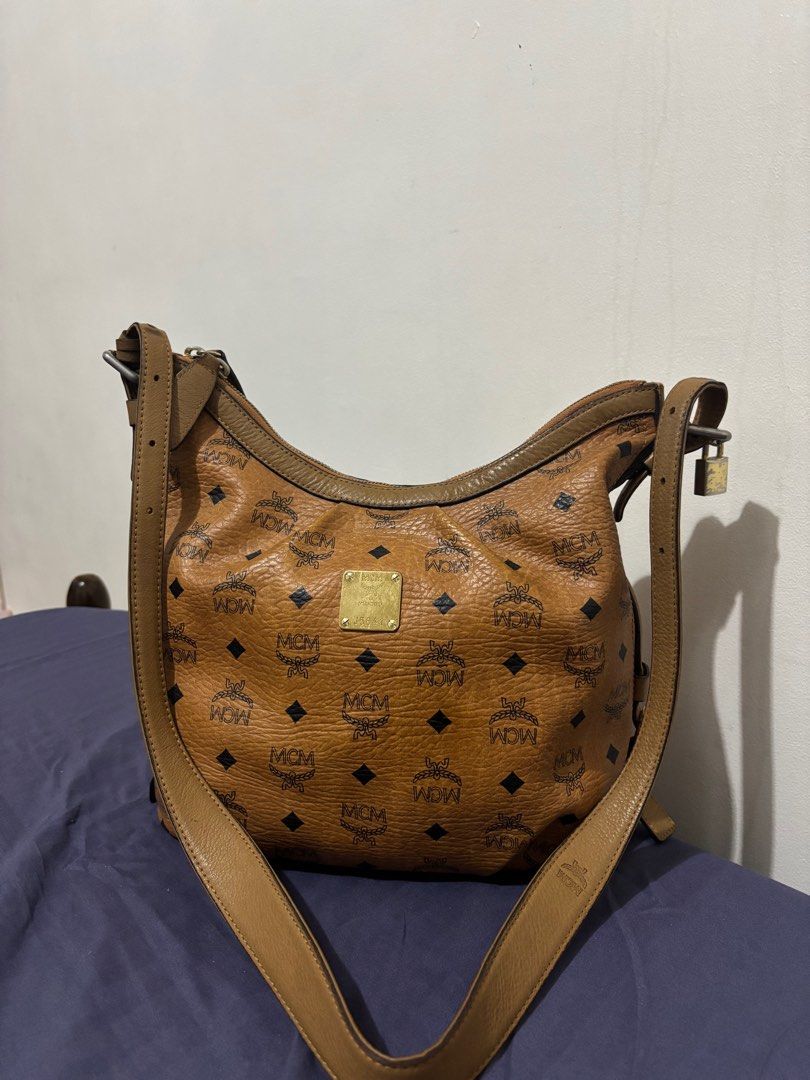 MCM Hobo Bag (Category: Luxury Bags & Wallets) located in Quezon City. Submitted by nini.corner (Listing ID 1412112357, Image 1). Description: MCM Hobo Bag • This bag was well loved, pls see pics for minor flaws • Spacious bag that can fit a lot of things • Mostly used for travel.