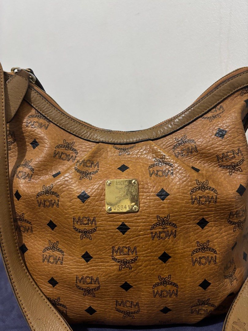 MCM Hobo Bag (Category: Luxury Bags & Wallets) located in Quezon City. Submitted by nini.corner (Listing ID 1412112357, Image 2). Description: MCM Hobo Bag • This bag was well loved, pls see pics for minor flaws • Spacious bag that can fit a lot of things • Mostly used for travel.