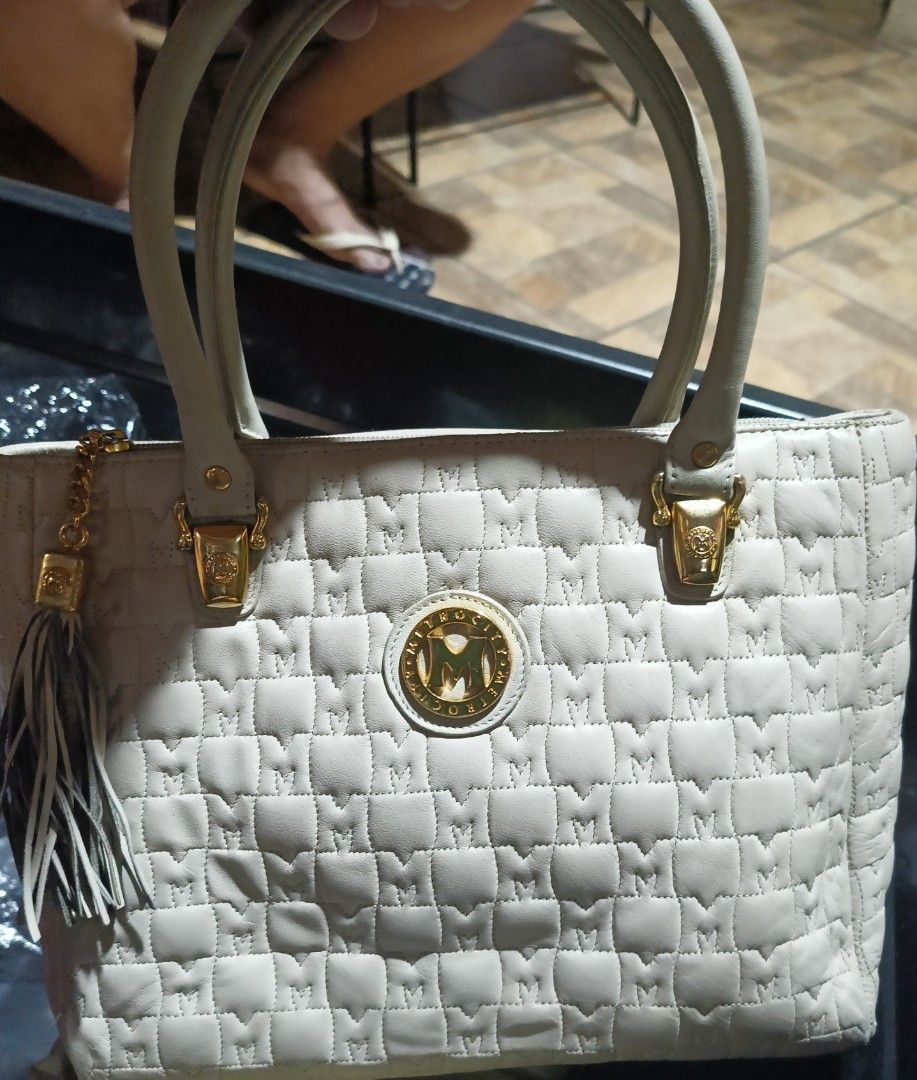 Metrocity Cream Handbag with Tassel (Category: Luxury Bags & Wallets) located in Rizal. Submitted by judithtillo19 (Listing ID 1412046159, Image 3). Description: Cream-colored Metrocity handbag with quilted design. Features gold hardware, tassel detail, and a back zippered pocket. Includes two handles. Some stain inside but it doesn't affect the beauty of the bag....Ready to use, already sanitized .