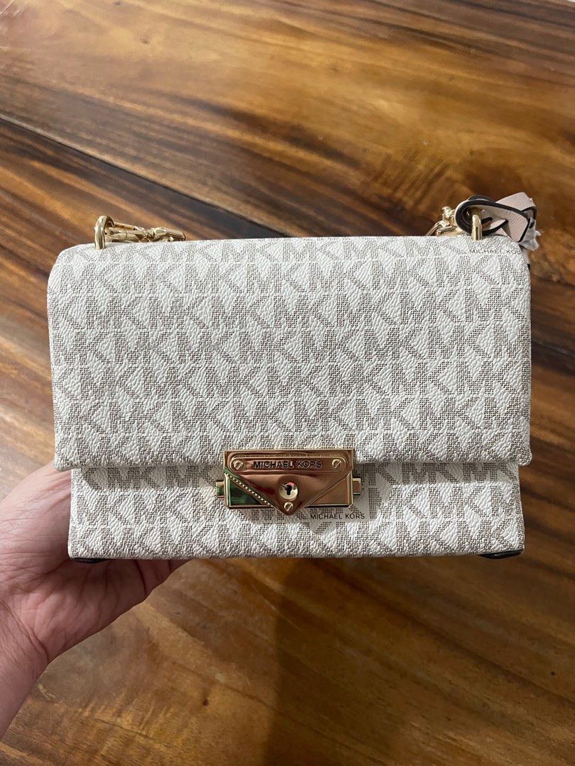 Michael Kors Cece Chain Shoulder Bag (Category: Luxury Bags & Wallets) located in Caloocan City. Submitted by gazellection.shop (Listing ID 1412112683, Image 3). Description: Authentic Michael Kors Cece Chain Shoulder Bag. Features a gold-tone chain strap and a flap closure with the Michael Kors logo. The bag has a beige and white MK logo pattern. Includes a dust bag and original tags. The interior has a pocket for cards..