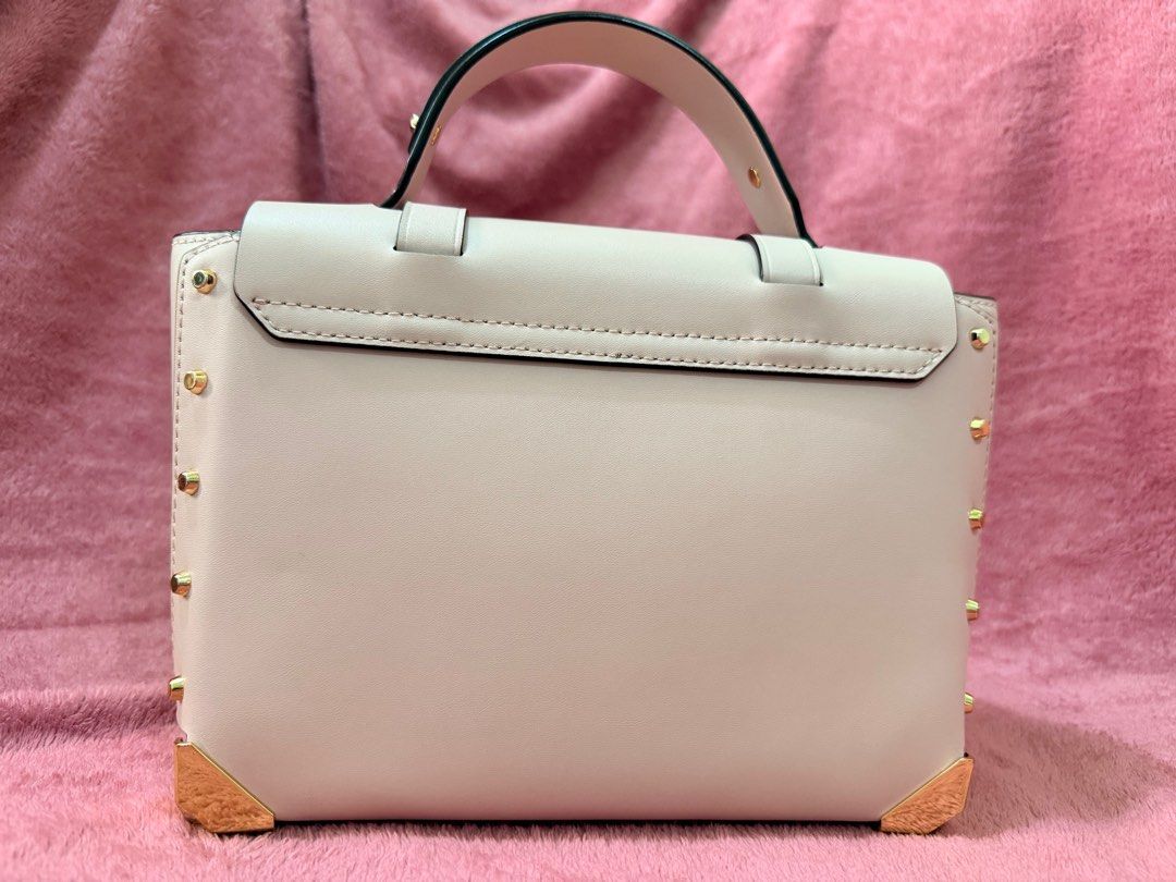 Michael Kors Manhattan (Category: Luxury Bags & Wallets) located in Pasig City. Submitted by catch.your.style (Listing ID 1411974672, Image 3). Description: - Authentic Michael Kors - Pre owned bought in USA - Blush pink in color - Top handle and detachable shoulder strap - Gold-tone hardware (lock, studs, corner accents) - Flap closure - Interior: patterned fabric lining, zippered pocket.
