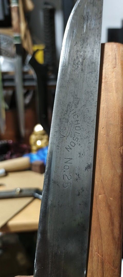 Nicholson No. 25 Knife with Sheath (Category: Knives & Chopping Boards) located in Polomolok. Submitted by dkljapansurplus (Listing ID 1412090596, Image 2). Description: - Vintage Nicholson No. 25 knife - Blade length 236mm - Includes wooden sheath - Blade marked "Nicholson USA No. 25" - Features a wooden handle.
