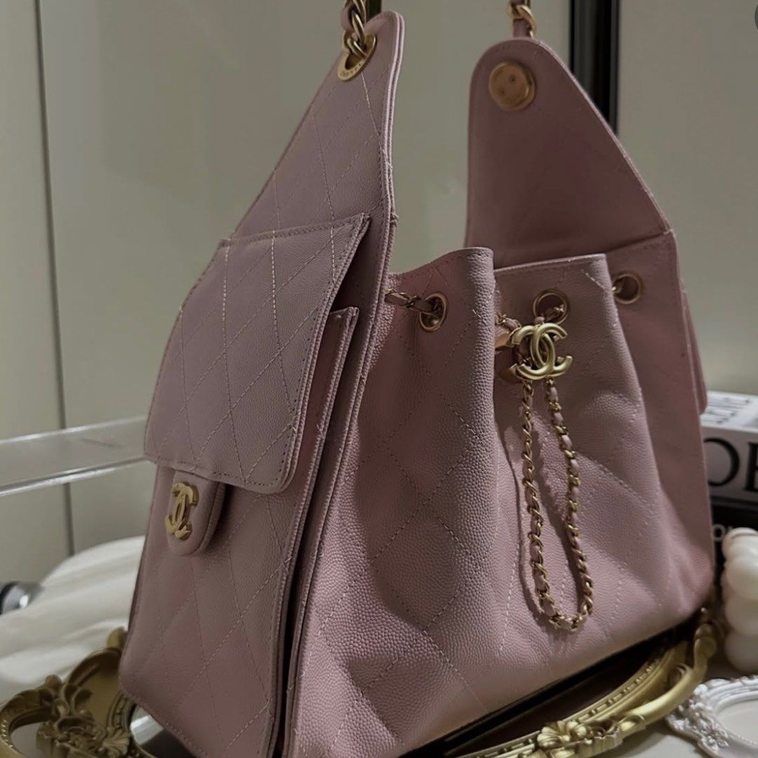 PREMIUM Chanel Pink Drawstring Handbag (Category: Luxury Bags & Wallets) located in Del Monte. Submitted by thingsidontuse (Listing ID 1412131018, Image 2). Description: - Chanel handbag - Soft pink color - Drawstring closure - Chain strap - Quilted design - Flap pocket with CC logo - Gold-tone hardware - Interior pocket with Chanel label - microchip .
