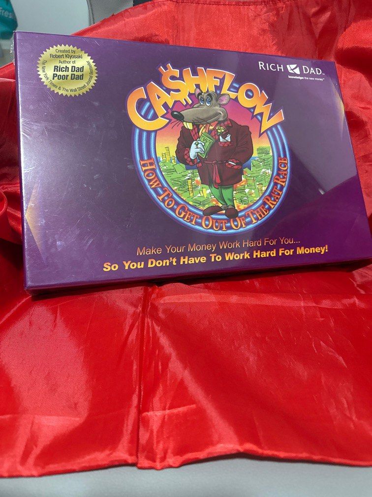 Rich Dad CASHFLOW board game (Category: Board Games & Puzzles) located in Singapore. Submitted by trust28 (Listing ID 1412130149, Image 1). Description: Rich Dad CASHFLOW board game. A cash flow board game teaches financial literacy, focusing on escaping the “rat race” by managing income, expenses, assets, and liabilities to build wealth..