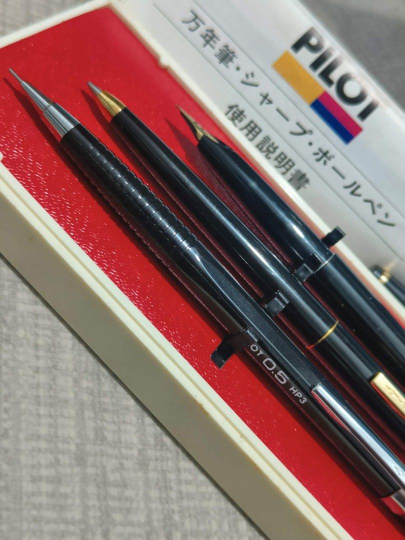 VINTAGE Pilot Pen Set with Case (Category: Stationery & School Supplies) located in Bacoor. Submitted by faith.hope.love28 (Listing ID 1412113484, Image 2). Description: - Vintage Pilot pen set - Includes: Fountain pen, ballpoint pen, and mechanical pencil - Original case and documentation included - Pens: Black with gold and silver accents - Mechanical pencil: OT 0.5 HP3 - Case: Gray with Pilot logo.