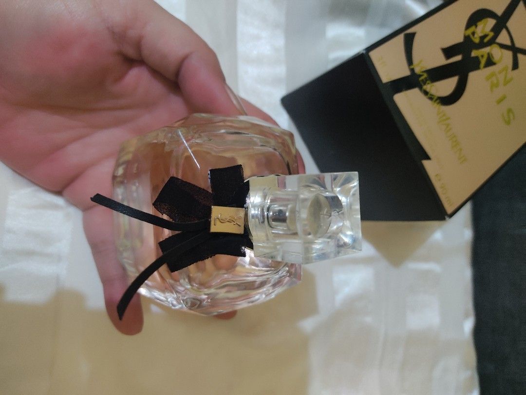 Yves Saint Laurent Mon Paris Eau de Parfum 90ml (Category: Fragrance & Deodorants) located in Cavite. Submitted by perfectfinds (Listing ID 1412108517, Image 2). Description: - Yves Saint Laurent Mon Paris Eau de Parfum - Size: 90ml - Bottle: Clear, square shape with pink liquid and black ribbon - Packaging: Includes original black box This is a replica I tried from an online seller. I don't love the scent. Sprayed a few times. .