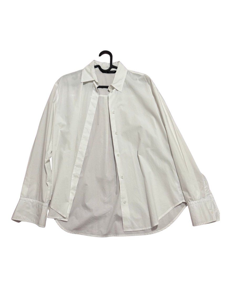 Zara Poplin Shirt (Category: Shirts) located in Malabon City. Submitted by decluttergyal (Listing ID 1412126677, Image 1). Description: - Size indicated is XS but can fit ‘til M - Worn once to work, I find it too big on me - White long-sleeved button-up shirt - Classic collar - Buttoned cuffs - Relaxed fit - Lightweight sheer fabric - Button-up front closure .