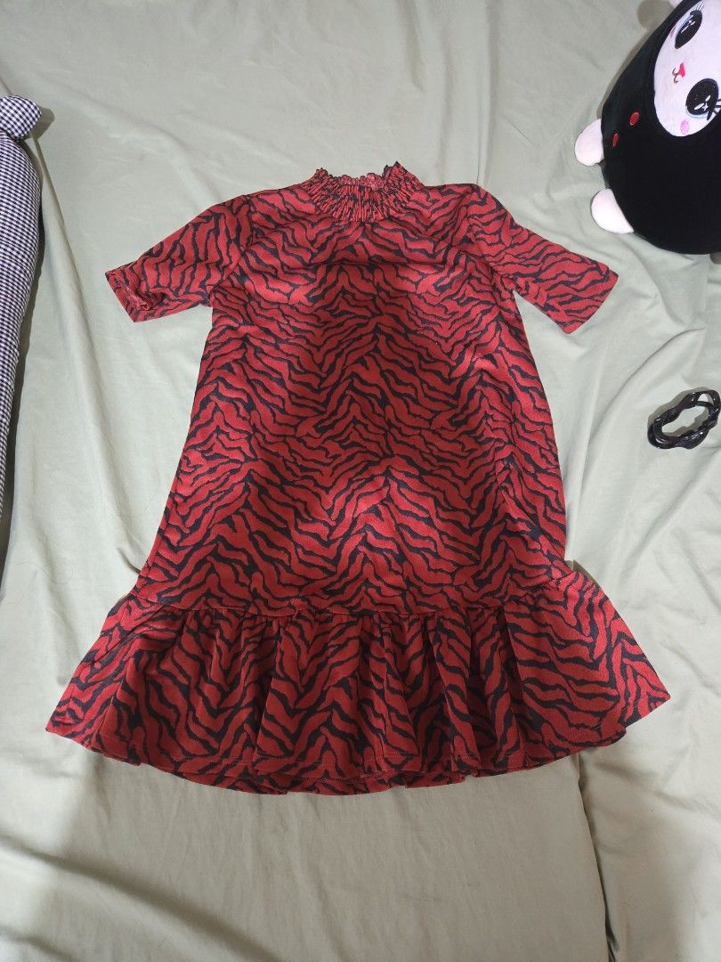 Zara Red Tiger Print Dress (Category: Dresses) located in Makati City. Submitted by abcd2020. (Listing ID 1412009019, Image 1). Description: - Zara dress with a bold red and black tiger print - Size S to M (as per label) - Features a stylish ruffled hem - Gathered neckline adds a flattering touch - Made in Morocco.