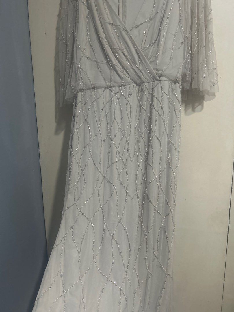Adrianna Papell Beaded Gown (Category: Evening dresses & gowns) located in Manila. Submitted by goodluckstuff (Listing ID 1412147240, Image 3). Description: Adrianna Papell beaded gown. Wrap style with flowy skirt. Very nice for weddings and other formal ocassions. Condition: Minor beadwork imperfections see pics 5 and 6, barely visible when worn. - Size: US 6 - Color: Neutral This gown is very beautiful when worn. The color is soft neutral perfe