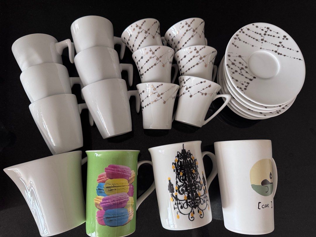 Assorted Coffee Cup Set (Category: Coffee & Tea Tableware) located in Singapore. Submitted by yojuju (Listing ID 1412288321, Image 1). Description: Set includes a variety of coffee cups and plates. Some cups are plain white, while others feature decorative designs. Perfect for a coffee lover! Price to be negotiated depends on what you need!.