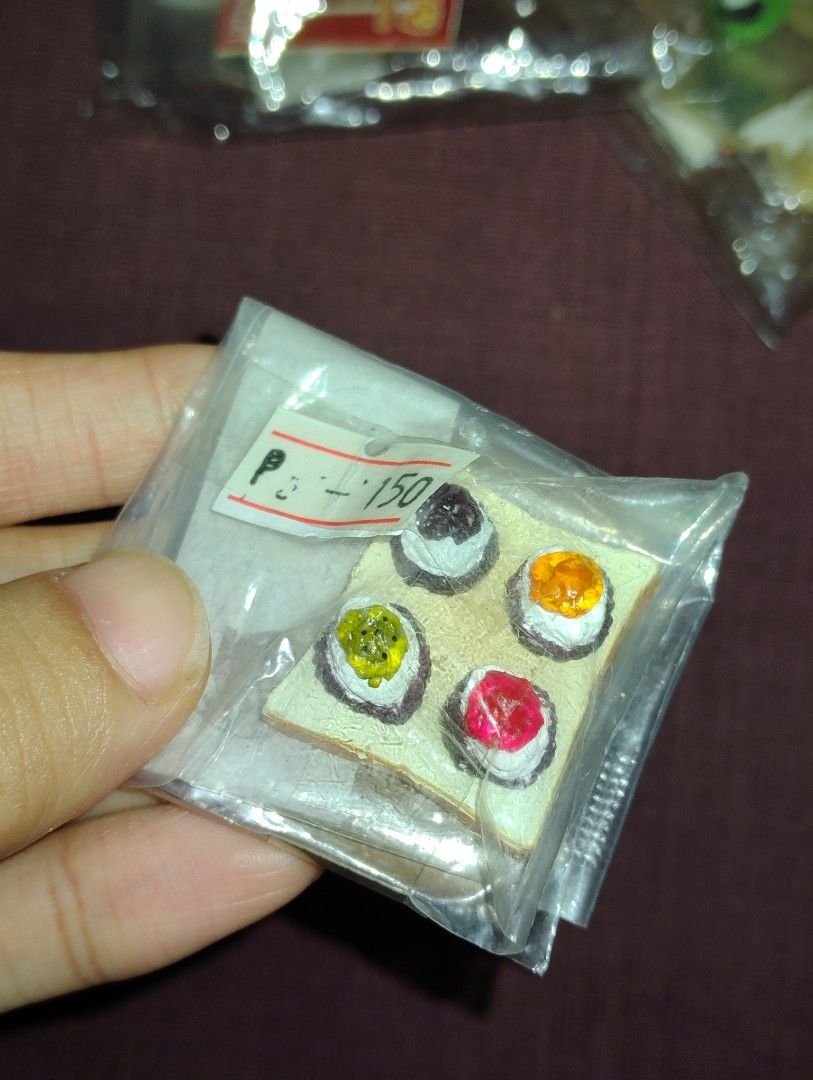 Bread with jam Miniature rement (Category: Designer & Blind Box Toys) located in Pasig City. Submitted by hazelscollectibles (Listing ID 1412154462, Image 1). Description: - Miniature sushi set - Includes five sushi pieces - Each piece has a different topping (black, yellow, red, green) - Comes on a small, rectangular base - Sealed in a clear plastic bag - Perfect for collectors - Unique gift idea.