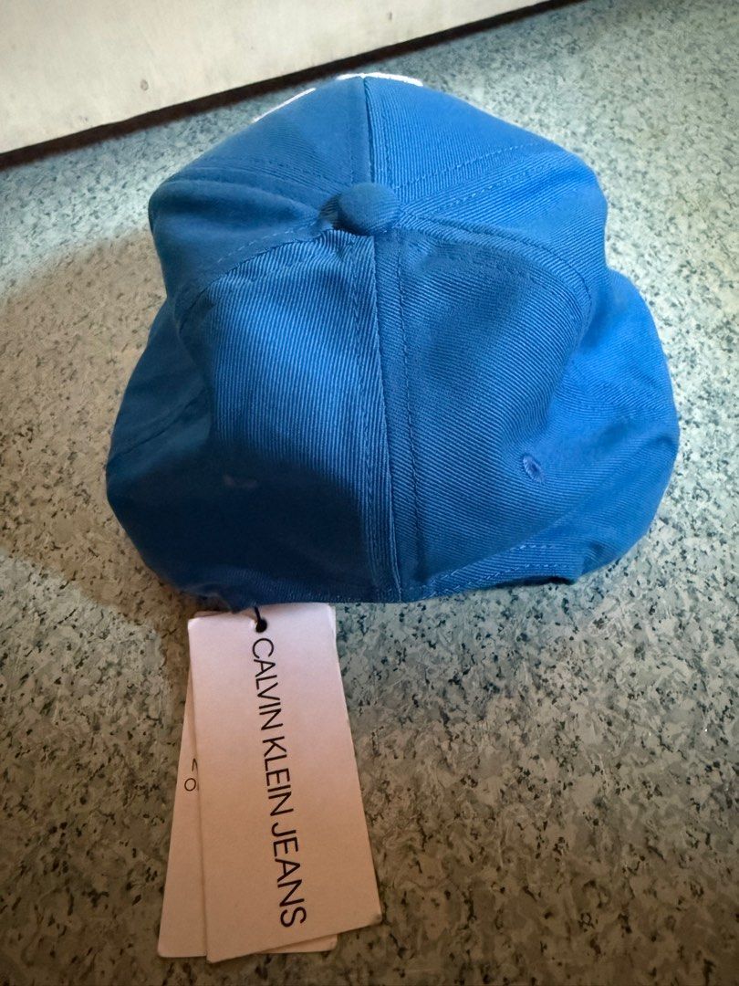 Calvin Klein Jeans Cap (Category: Caps & Hats) located in Bacoor. Submitted by jayps07 (Listing ID 1412178815, Image 3). Description: - Brand: Calvin Klein Jeans - Color: Blue - Features: Embroidered Calvin Klein Jeans logo - Condition: Unworn - Includes: Original tag.
