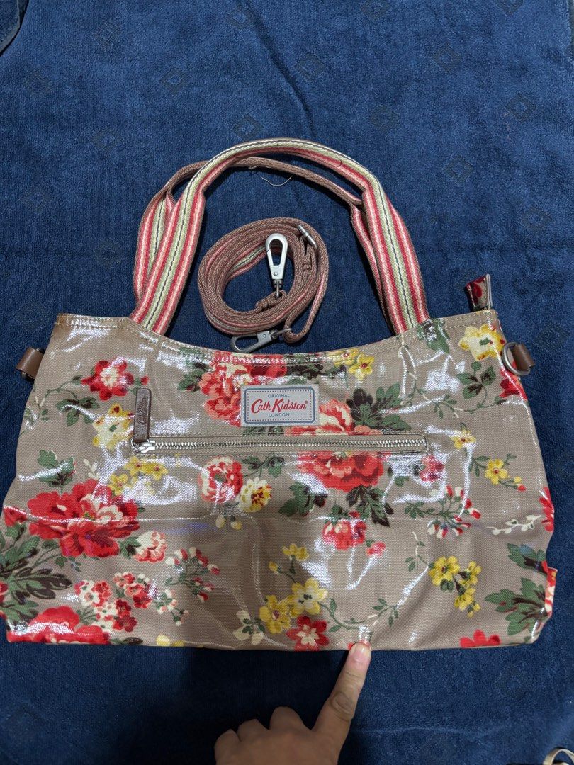 Cath Kidston Floral Handbag with long Strap (Category: Shoulder Bags) located in Makati City. Submitted by issa124 (Listing ID 1412322592, Image 1). Description: - Authentic Cath Kidston handbag with long sling Strap - Beautiful floral pattern - Top handle and detachable shoulder strap - Zippered main compartment - Interior zippered pocket - Floral interior lining - Glossy finish - Durable material Size:15x8.5x5 inches Issue: discoloration on las