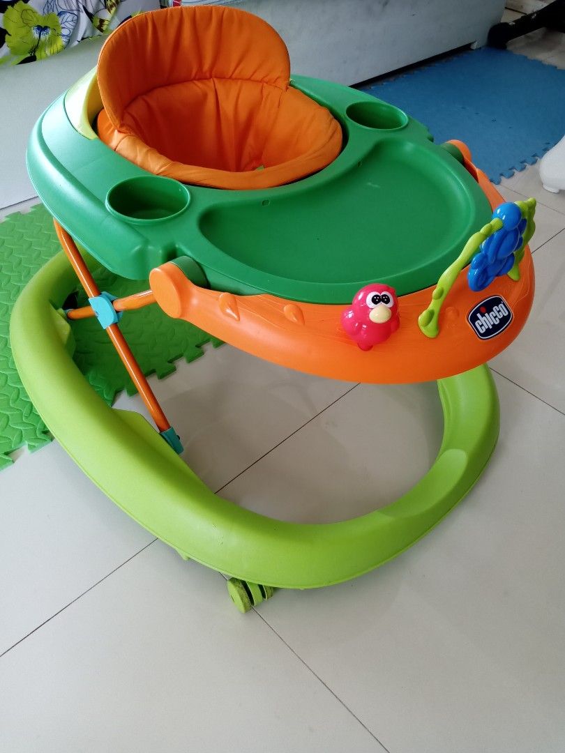 Chicco Walky Talky Baby Walker (Category: Infant Playtime) located in Catarman. Submitted by aninaj (Listing ID 1412246559, Image 2). Description: - Chicco Walky Talky Baby Walker - Color: Green and orange - Seat color: Orange - Sturdy base for stability - In good working condition.