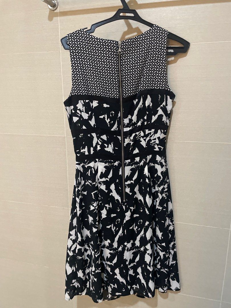 Esprit Black and White Printed Dress (Category: Dresses) located in Mandaluyong City. Submitted by beautyfashdeclutter (Listing ID 1412216782, Image 3). Description: - Esprit dress in black and white - Features a unique geometric pattern on the top - Striking abstract design on the skirt - Sleeveless design - Knee-length style - Convenient zipper closure at the back - Suitable for various occasions.