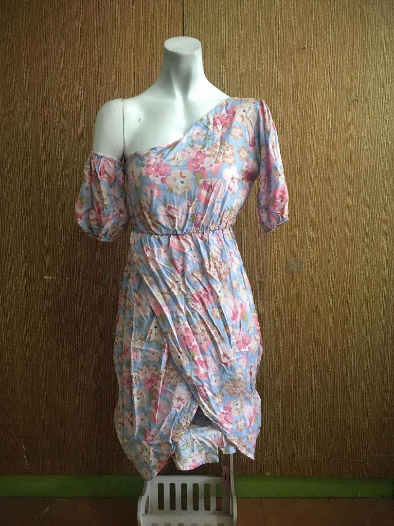 Floral One-Shoulder Dress (Category: Dresses) located in Caloocan City. Submitted by _misskaye (Listing ID 1412272140, Image 1). Description: - Floral print dress - Colors: Blue and pink - Design: One-shoulder with short sleeve - Features: Elasticated waist, wrap-style skirt - Length: Knee-length - Ideal for: Casual wear, summer events ⚜️ Location: Brgy. 167, Caloocan City ⚜️ MOD: J&T or LALAMOVE ⚜️ no cancellation/exchange/refund ⚜️ MOP: GCASH o