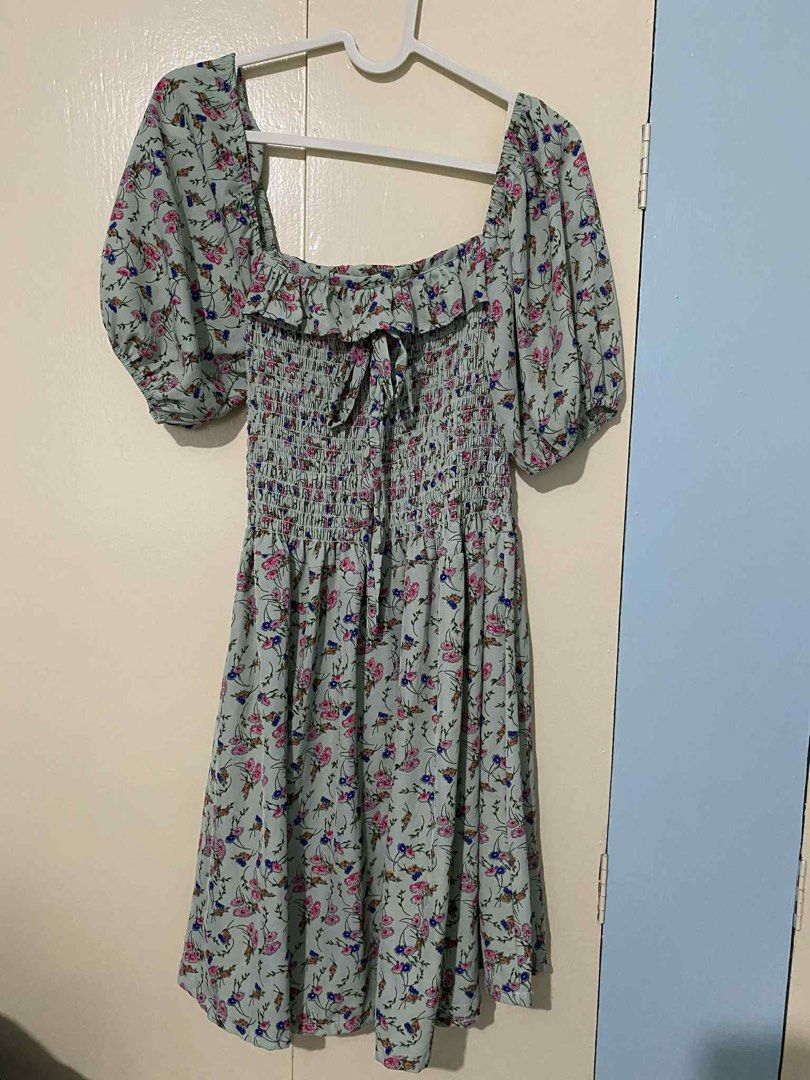 Floral Puff Sleeve Dress (Category: Dresses) located in Manila. Submitted by mackyrena (Listing ID 1412280591, Image 1). Description: - Square neckline - Puff sleeves - Smocked bodice - Tie detail at bust - Flowy skirt - Light blue with pink and blue floral print.