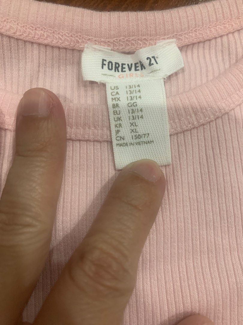 Forever 21 Ribbed T-shirt - Pink (Category: Shirts) located in Manila. Submitted by chuchay28 (Listing ID 1412265222, Image 2). Description: - Forever 21 pink ribbed t-shirt - Size: XL - Features: Round neckline, short sleeves - Condition: Good - Made in Vietnam.