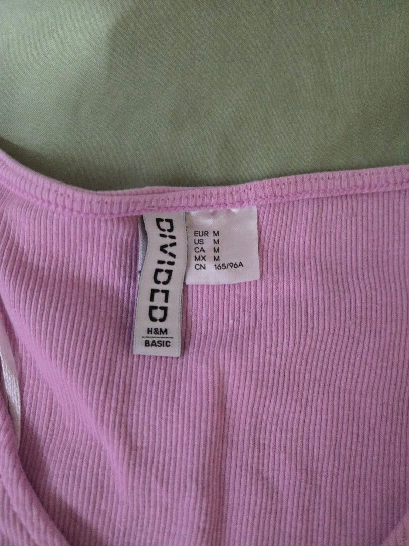 H&M Divided Basic Ribbed Top (Category: Shirts) located in Makati City. Submitted by abcd2020. (Listing ID 1412210142, Image 2). Description: - H&M Divided Basic pink ribbed top - Size: S to M - Design: Knot detail at front, V-neck - Sleeves: Short - Material: Stretchy and comfortable - Perfect for casual wear.