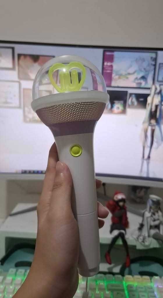 IU Official Light Stick Ver. 3 I-KE (Category: K-Wave Merchandise) located in Caloocan City. Submitted by cyllionox (Listing ID 1412272555, Image 1). Description: - Official IU light stick - White handle with purple and gold top - Clear dome with heart-shaped design - Includes original box and strap - Button located on the handle.