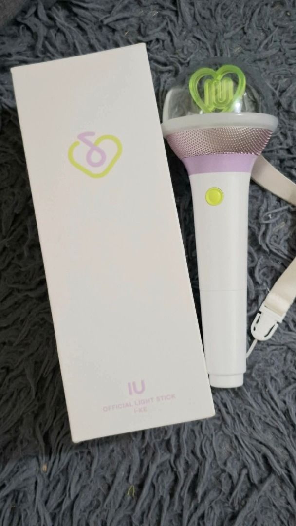 IU Official Light Stick Ver. 3 I-KE (Category: K-Wave Merchandise) located in Caloocan City. Submitted by cyllionox (Listing ID 1412272555, Image 2). Description: - Official IU light stick - White handle with purple and gold top - Clear dome with heart-shaped design - Includes original box and strap - Button located on the handle.