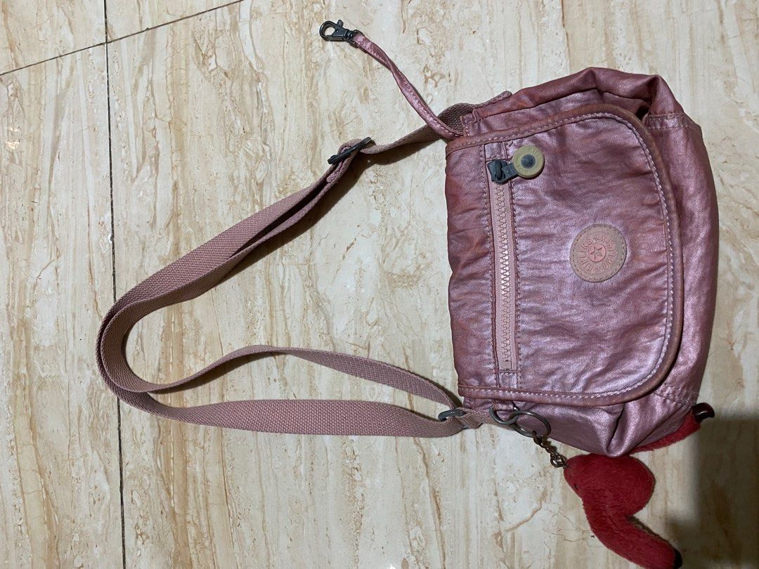 Kipling Metallic Pink crossbody shoulder bag (Category: Cross-body Bags) located in Rodriguez. Submitted by _denggg (Listing ID 1412300515, Image 3). Description: Metallic pink Kipling crossbody - need wash - well used - can shorten the strap para pwede shoulder - washable stains - for bagets still slightly nego. dm me, so we can negotiate :)) rfs: my mom needs to down size her kipling bag collection na :)) (she’s a kipling lover) .