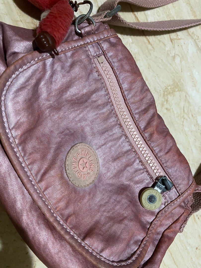 Kipling Metallic Pink crossbody shoulder bag (Category: Cross-body Bags) located in Rodriguez. Submitted by _denggg (Listing ID 1412300515, Image 2). Description: Metallic pink Kipling crossbody - need wash - well used - can shorten the strap para pwede shoulder - washable stains - for bagets still slightly nego. dm me, so we can negotiate :)) rfs: my mom needs to down size her kipling bag collection na :)) (she’s a kipling lover) .