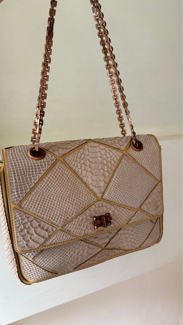 Lanvin Python Leather Shoulder Bag (Category: Luxury Bags & Wallets) located in Malolos. Submitted by flapnbloom.ph (Listing ID 1412163081, Image 3). Description: - Python leather shoulder bag - Geometric design - Chain strap, Rosegold, shoulder only, not convertible - Interior zippered pocket - Clasp flap closure - Lanvin logo on interior zipper pull - Discounted price due to signs of storage but bag is lighyly used.