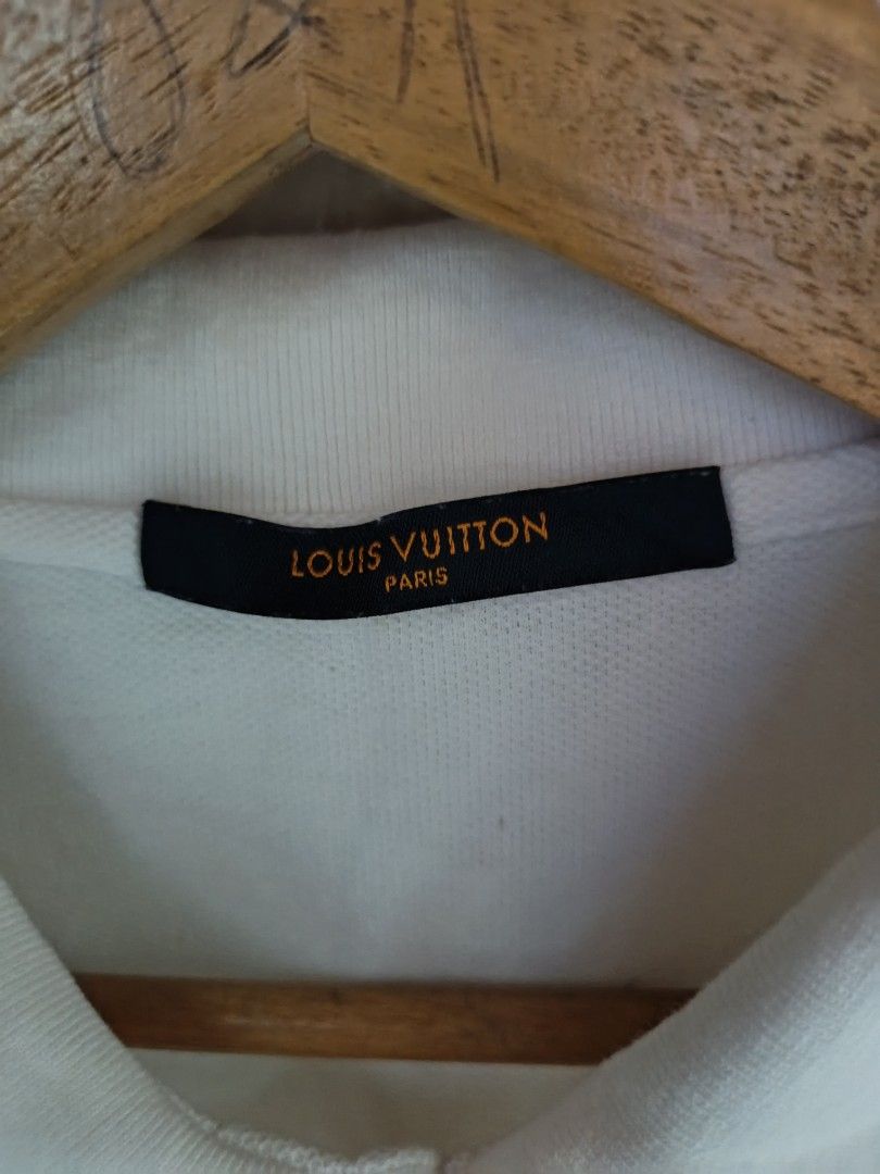 Louis Vuitton Polo Shirt - White (Category: Tshirts & Polo Shirts ) located in Goa. Submitted by kaye_dee (Listing ID 1412211985, Image 3). Description: - Authentic Louis Vuitton polo shirt - Color: White - Features the iconic Louis Vuitton logo - Size: XXL - Made in Italy - Classic polo collar and short sleeves - Includes washing instructions label - A stylish and timeless piece.