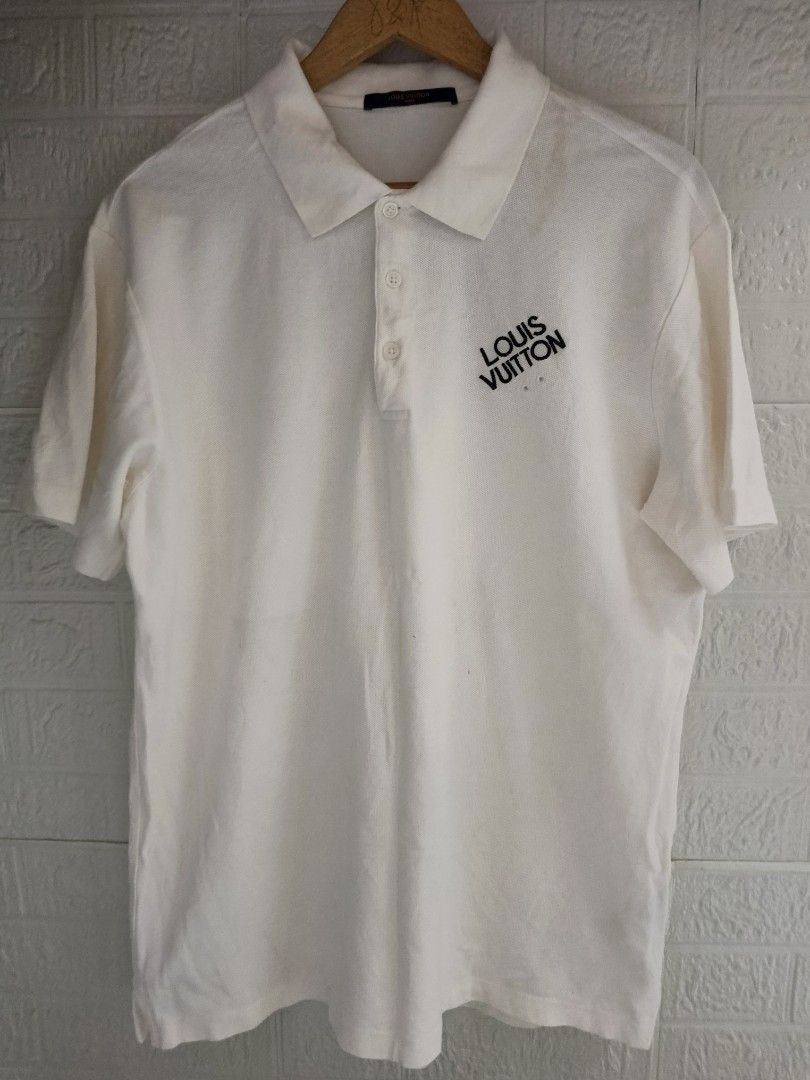 Louis Vuitton Polo Shirt - White (Category: Tshirts & Polo Shirts ) located in Goa. Submitted by kaye_dee (Listing ID 1412211985, Image 1). Description: - Authentic Louis Vuitton polo shirt - Color: White - Features the iconic Louis Vuitton logo - Size: XXL - Made in Italy - Classic polo collar and short sleeves - Includes washing instructions label - A stylish and timeless piece.