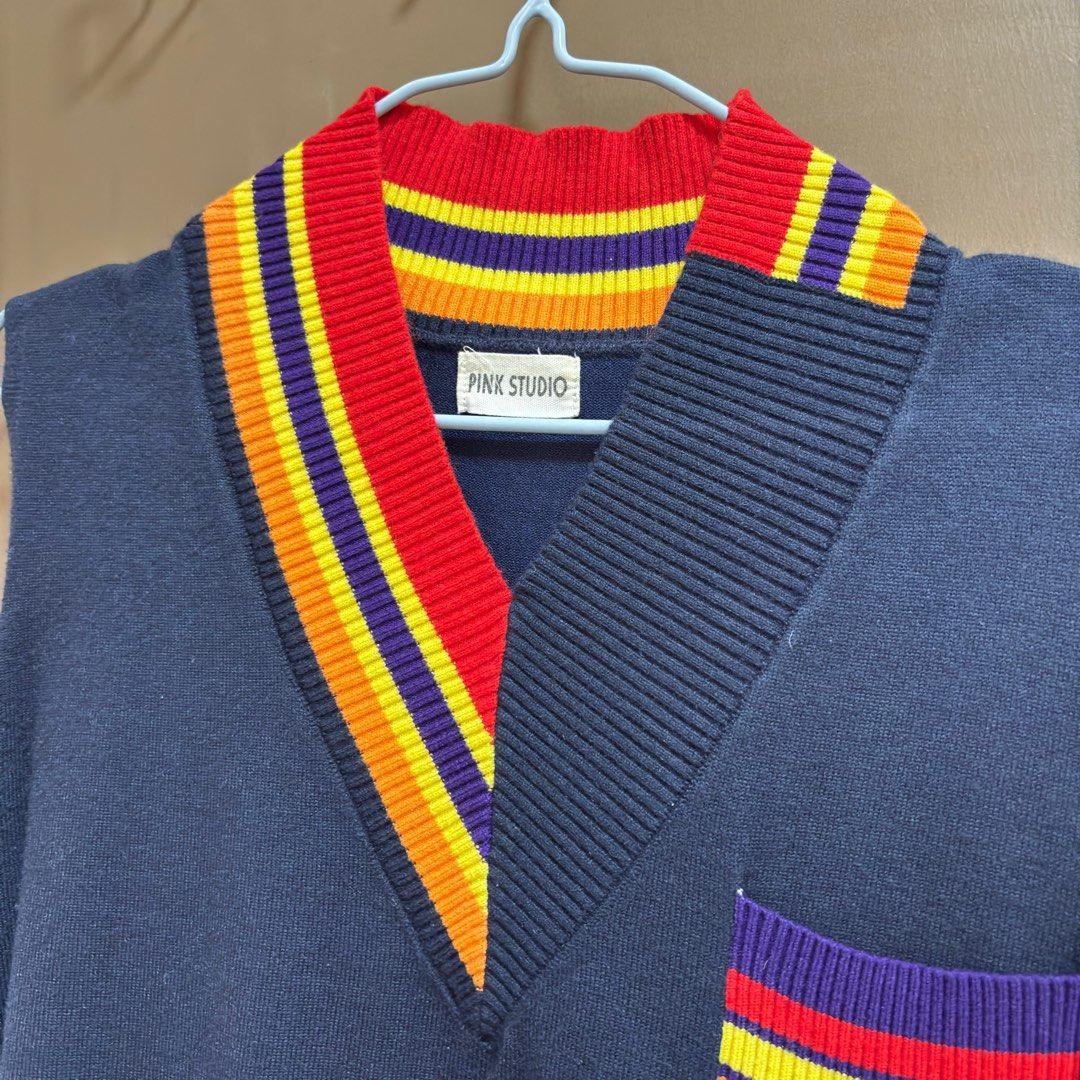 Pink Studio Sleeveless Vest (Category: Sleeveless) located in Balanga. Submitted by heyyletsdeclutter (Listing ID 1412202479, Image 3). Description: - Pink Studio sleeveless vest - Navy blue body with V-neck - Colorful striped collar and pocket accents - Unique pocket design with purple base - Perfect for layering.