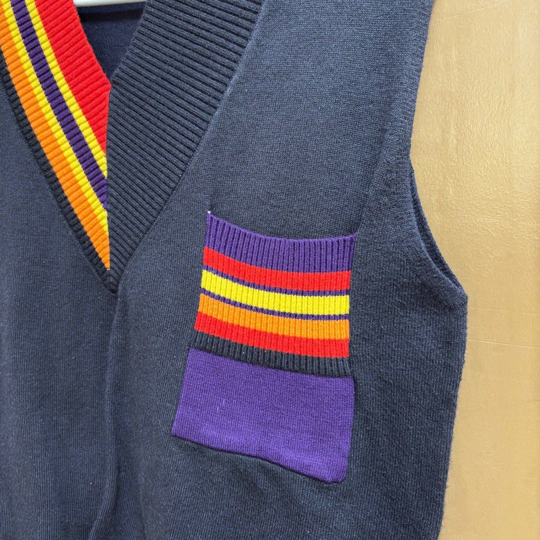 Pink Studio Sleeveless Vest (Category: Sleeveless) located in Balanga. Submitted by heyyletsdeclutter (Listing ID 1412202479, Image 2). Description: - Pink Studio sleeveless vest - Navy blue body with V-neck - Colorful striped collar and pocket accents - Unique pocket design with purple base - Perfect for layering.
