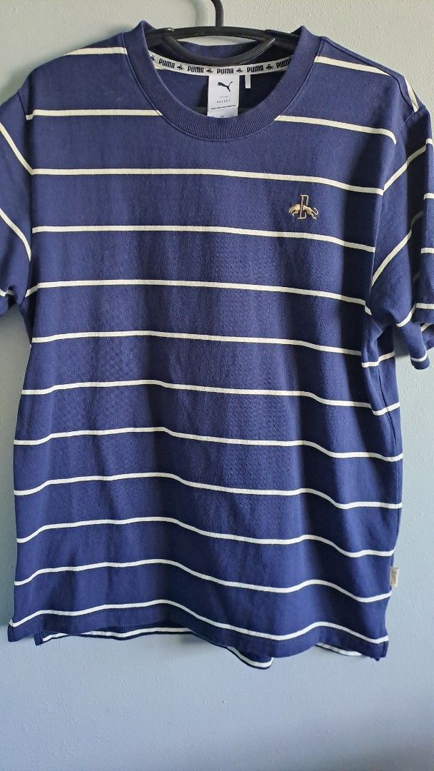 Puma Striped Crew Neck T-shirt (Category: Tshirts & Polo Shirts ) located in Munoz. Submitted by mrkcl_ (Listing ID 1412153346, Image 2). Description: - Navy blue crew neck t-shirt - Features vertical white stripes - Puma logo on chest - Long sleeves - Size: XS Fits Medium - Condition: Excellent to as new.