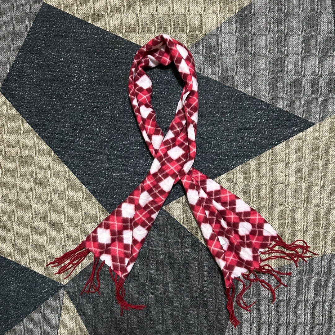 Red and Pink Argyle Fleece Scarf (Category: Scarves) located in Cabuyao City. Submitted by joaquinb18 (Listing ID 1412311382, Image 2). Description: Red and Pink Argyle Fleece Scarf Pattern: A repeating diamond motif that covers the entire length of the fabric. Fringe: The ends are finished with self-fringe (tassels made from the same yarn or fabric as the scarf) in a solid burgundy color. Construction: It is a rectangular “muffler” style scarf, 