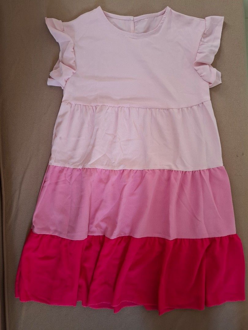 SHEIN Pink Tiered Dress (Category: Babies & Kids Fashion) located in Cavite. Submitted by l.m.m. (Listing ID 1412159403, Image 1). Description: - Pink tiered dress - Ruffle sleeves - Round neckline - Size S - Waist: approximately 17 inches - Polyester - used once.