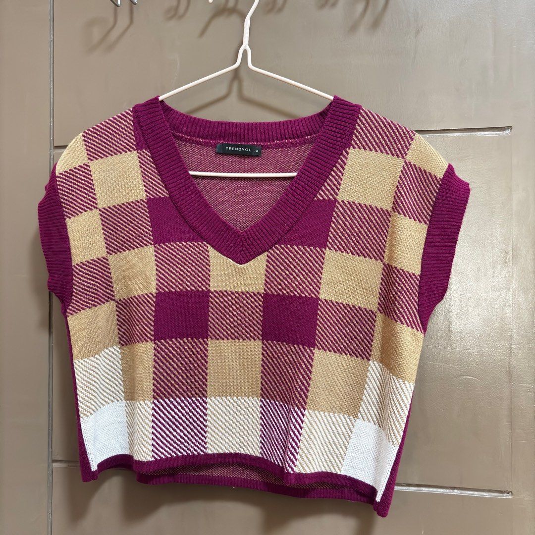 Trendyol Zalora Checkered V-Neck Vest Medium (Category: Sleeveless) located in Balanga. Submitted by heyyletsdeclutter (Listing ID 1412201494, Image 1). Description: - Trendyol vest from Zalora - V-neck design - Checkered pattern (purple & beige) - Sleeveless - Cropped length - Size: M - Knit material.