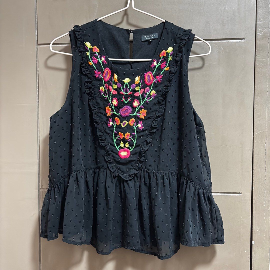 ZALORA Embroidered Sleeveless Top (Category: Sleeveless) located in Balanga. Submitted by heyyletsdeclutter (Listing ID 1412251799, Image 1). Description: - ZALORA black sleeveless top - Colorful floral embroidery - Round neckline - Ruffled trim - Peplum hem - Subtle polka dot texture - Size: XL.