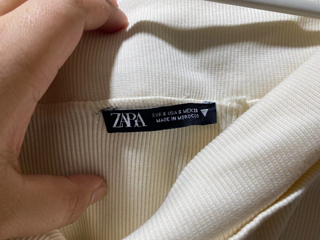 Zara Off-Shoulder Ribbed Top (Category: Blouses) located in Pasay City. Submitted by _jkching (Listing ID 1412271930, Image 2). Description: - Zara off-shoulder top - Cream color - Size S - Ribbed texture - Long sleeves - Condition: Tear on sleeve.