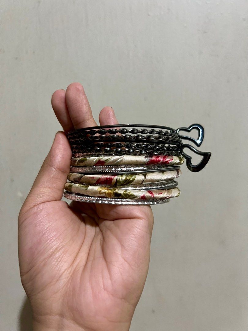 Assorted Bangles Set (Category: Bracelets) located in Manila. Submitted by ponyows (Listing ID 1412427220, Image 3). Description: Collection of bangles and bracelets, including some fabric-wrapped bangles and a set of gunmetal bangles with heart charms. mop: gcash/bpi mod: lalamove / j&t location: sampaloc manila no return & refund .